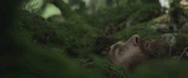 John (Paul Higgins) close up in the woods